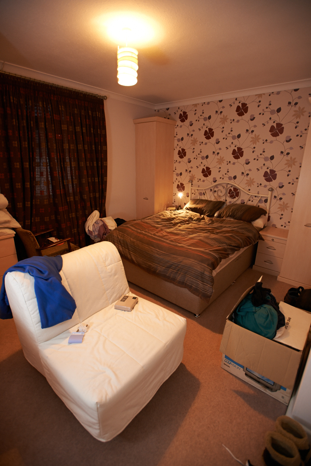 The bedroom. The big white chair is probably going to move somewhere else.
